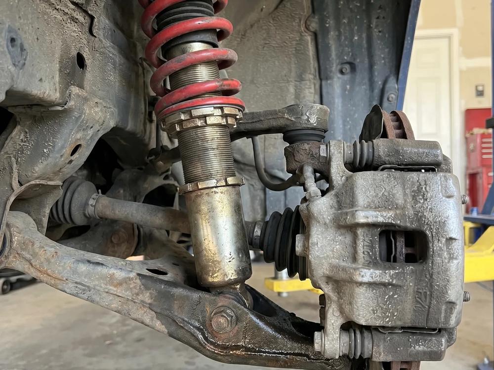 Coil-over strut and brake assembly on a lifted car